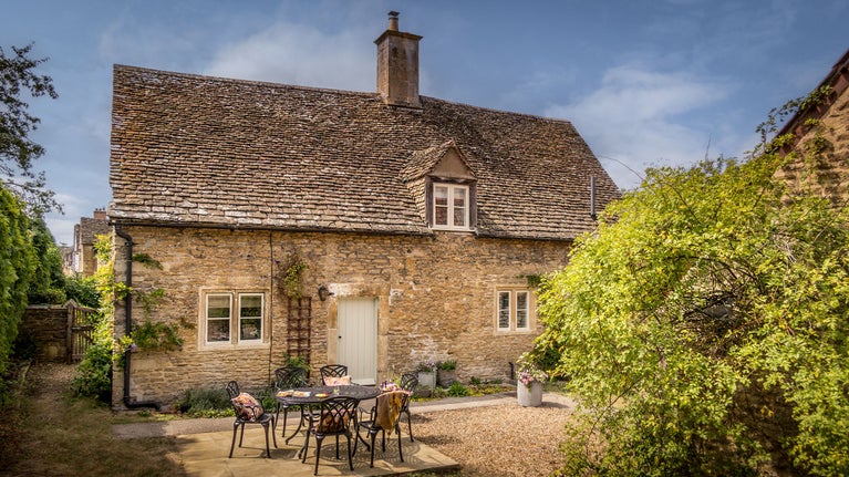 The back garden at 20 Church Street, with gravel and patio with dining table and chairs, Wiltshire